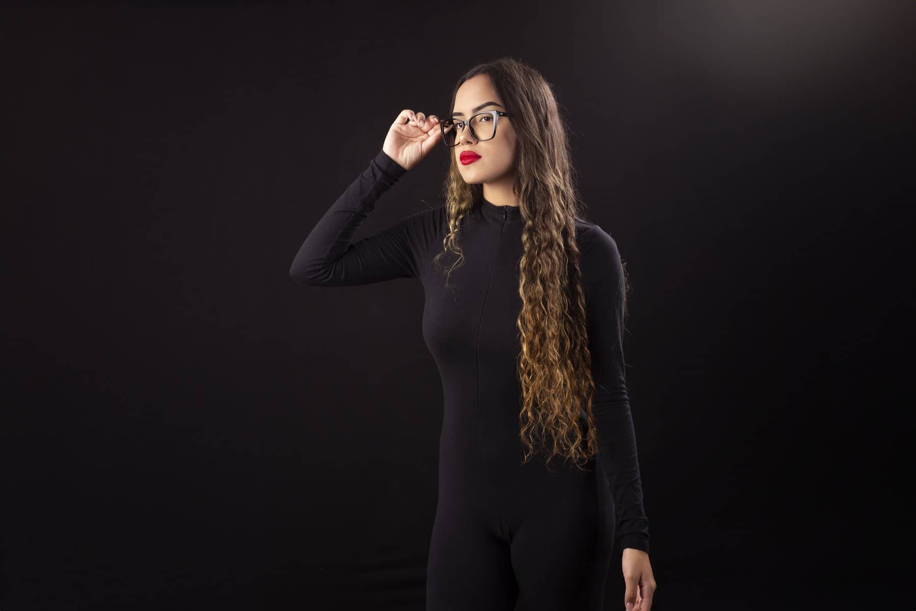 Mulher de cabelos longos ajustando os óculos de grau